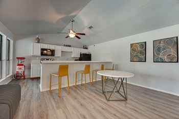 A kitchen with a white ceiling and a white counter.